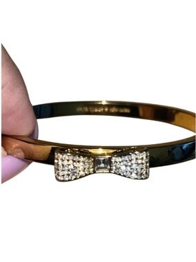 Kate Spade New York "Ready Set Bow" hinged bangle bracelet.